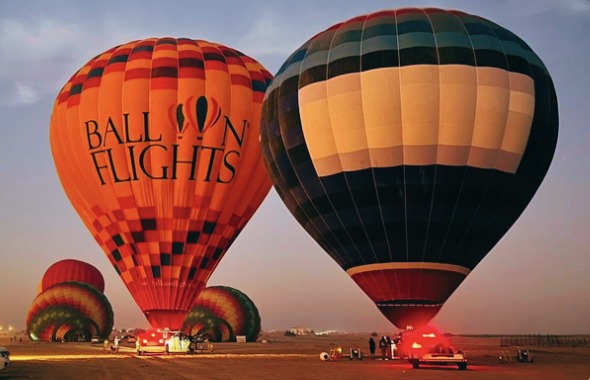 Hot air balloons inflating at sunrise in the Dubai desert 1